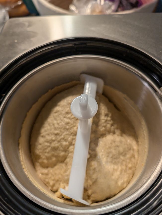 Thick pumpkin gelato holding ridges around the machine paddle