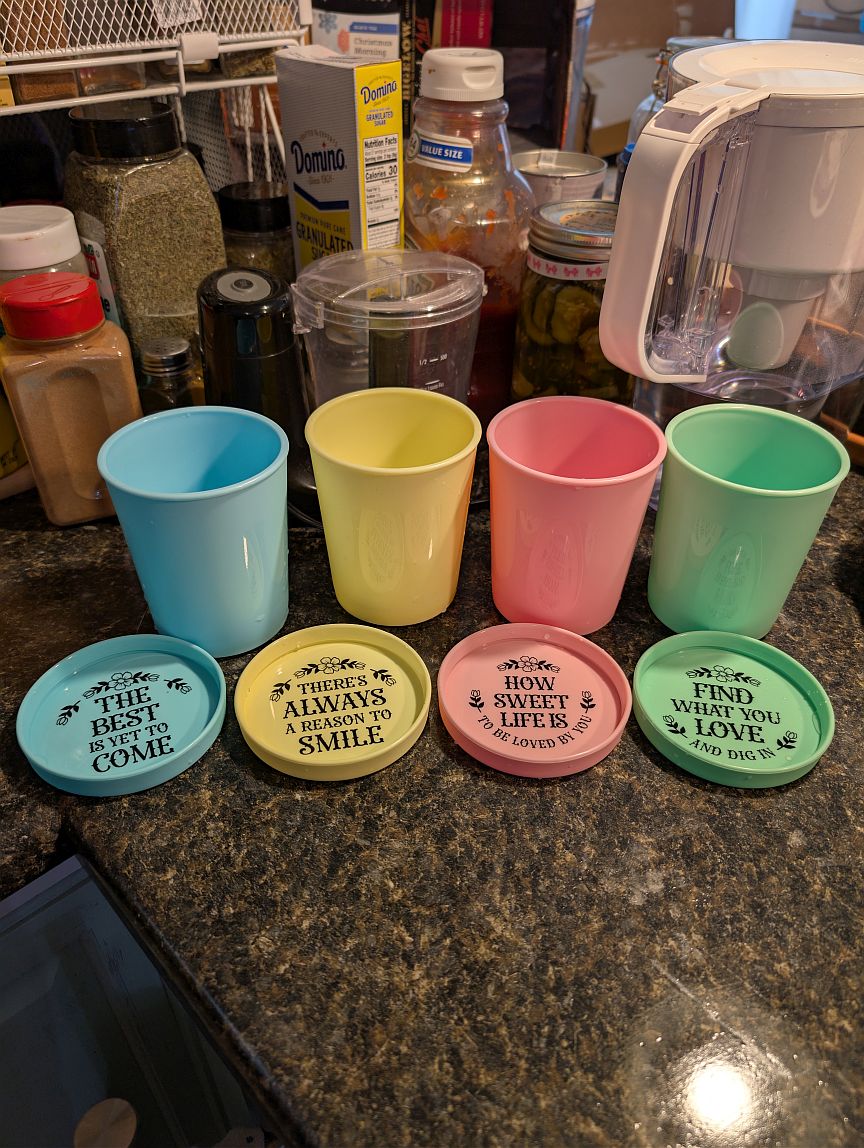 Four colorful lidded cups ready to hold pumpkin gelato