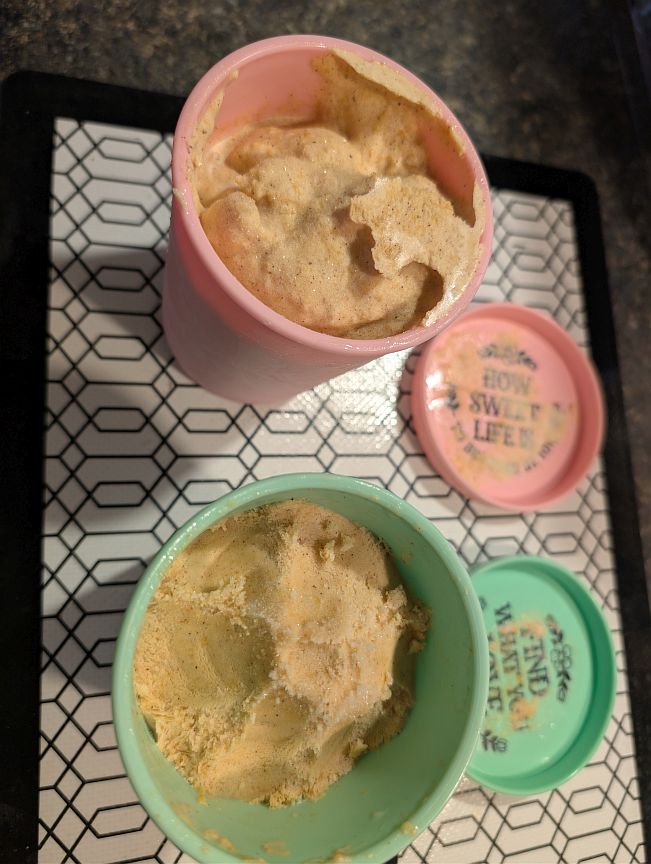 Firm frozen pumpkin gelato in pink and green serving cups